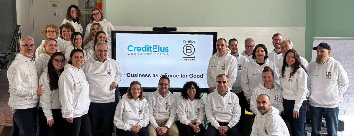 Group of smiling person in front of BCorp screen